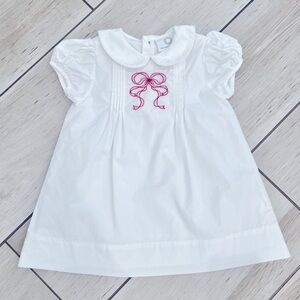White dress with red bow embroidery